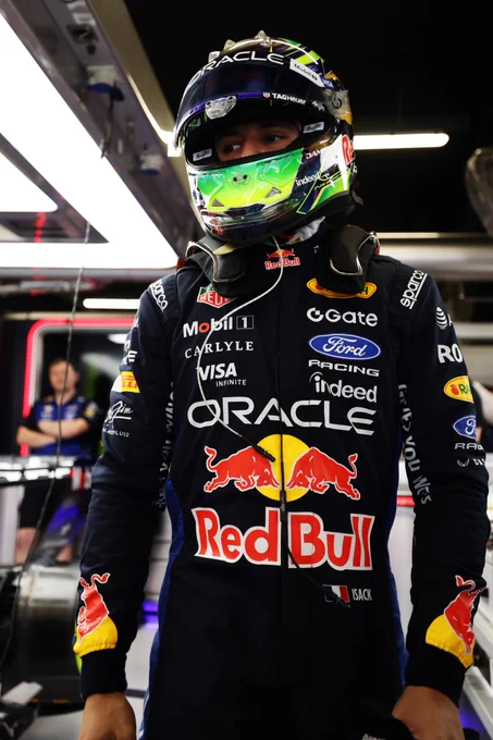 Isack in the garage, wearing full suit and helmet
