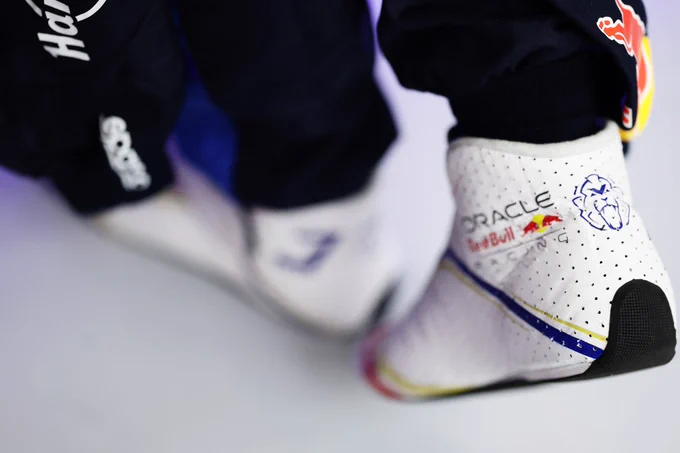 Max's white boots, which feature the MV and ORBR logos.