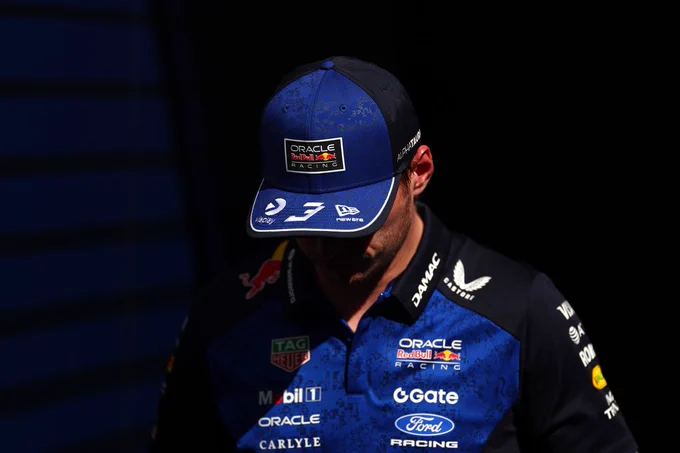 Max in team kit, looking to the floor, showing the brim of his cap.