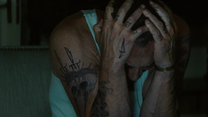From Cape Fear. Javier Bardem as Max Cady is seen in a closeup holding his head in his hands.