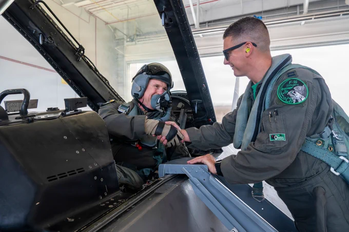Gen. Gregory Guillot, commander, North American Aerospace Defense Command and U.S. Northern Command, shakes hands with Capt. TJ Copic, a fighter pilot, assigned to the Ohio National Guard's 180th Fighter Wing, before take-off for an aerospace control alert training mission, in Swanton, Ohio, June 11, 2026. As part of the NORAD enterprise, the 180th FW plays a pivotal role in providing aerospace control for continental defense. (U.S. Air National Guard photo by Senior Airman Camren Ray)