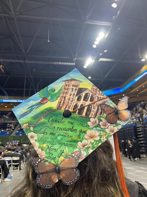 A cap decorated with Royce Hall and butterflies. A tribute to her parents in Spanish