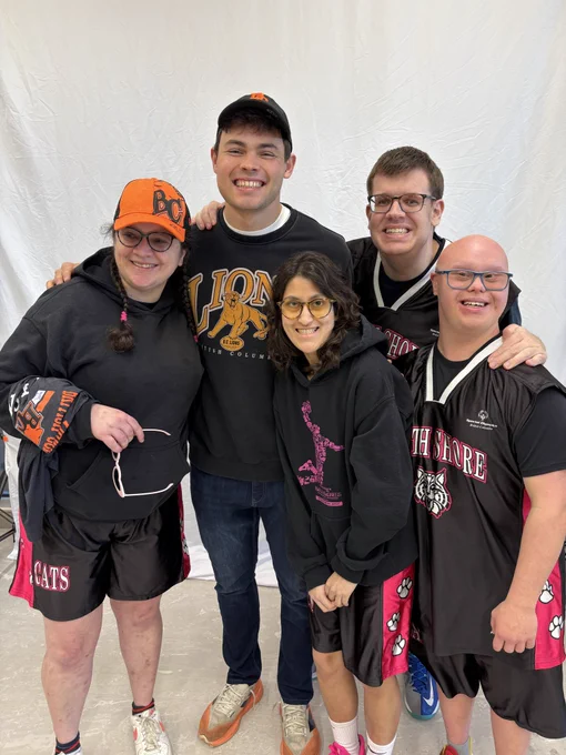 Smiling Special Olympics athletes with BC Lions quarterback Nathan Rourke