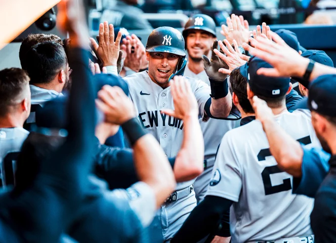 Paul Goldschmidt gets high-fives in the Yankees dugout after hitting a home run.