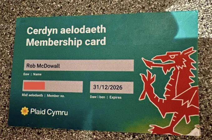 Green membership card for Plaid Cymru. Header reads “Cerdyn aelodaeth - Membership card” Name: “Rob McDowall” Member number is redacted. Expiry date is “21/12/2026”. A red Welsh dragon is shown on the bottom right of the membership card.