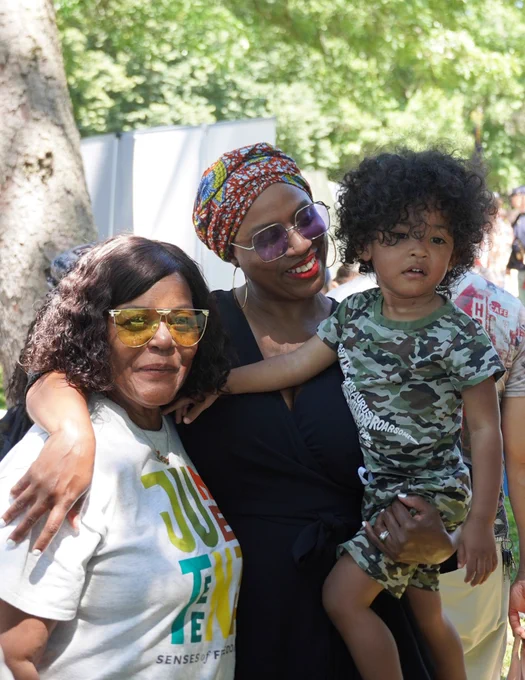 Rep. Ayanna Pressley poses for a photo with a family at Hyde Park's Juneteenth Joy Celebration.