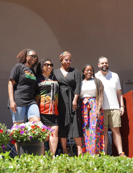 Rep. Ayanna Pressley poses for a photo with local leaders after providing remarks.