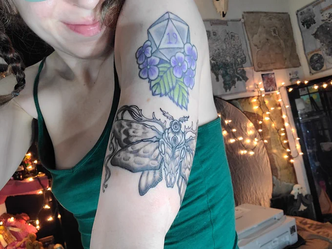 Div showing a new moth/skull tattoo, in the style of Caitlin Hackett . 