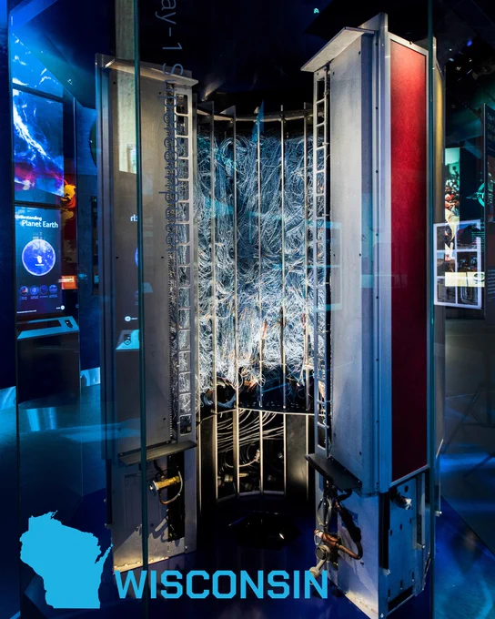 Cray-1 supercomputer on display at the museum. The word "WISCONSIN" and a silhouette of the state are prominently displayed at the bottom of the image.