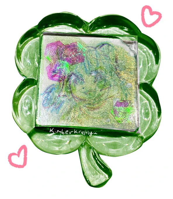 faint color pencil drawing of Marky on a glittery piece of paper. he is framed in a shiny four-leaf clover