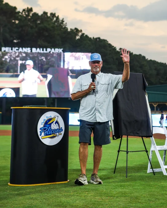 Number retirement ceremony for former Pelicans Manager, Brian Snitker. The number 38 was retired pregame at Pelicans Ballpark. The podium nearby displays the Myrtle Beach Pelicans logo.