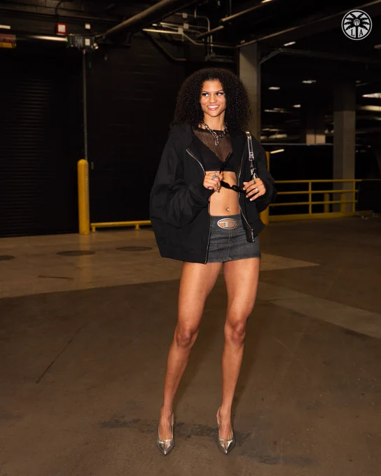 Rae Burrell wearing a Jean skirt and black mesh top