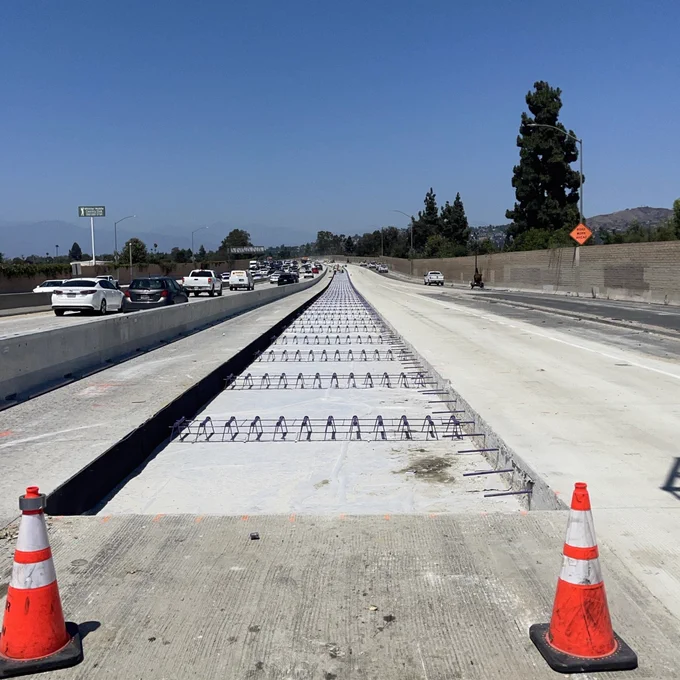 Lean concrete base covered by plastic "bond breaker" and dowel baskets. 