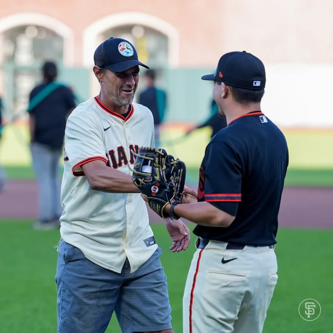 Chris Wondolowki shakes hands after he threw out the first pitch at the Cubs vs. Giants game