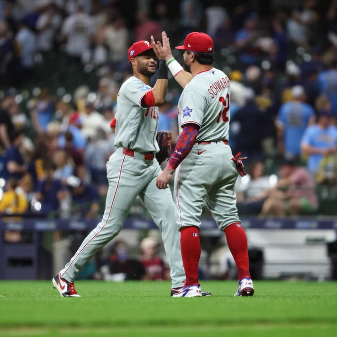 Kyle Schwarber gives Justin Crawford a high-five after Saturday's win.