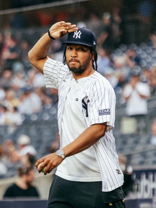 Jalen Brunson salutes as he takes the field at Yankee Stadium to throw out the ceremonial first pitch. 