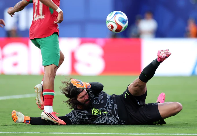 Alisson complete's a double save against Morocco in the 99th minute of the match during Brazil's FIFA World Cup opener