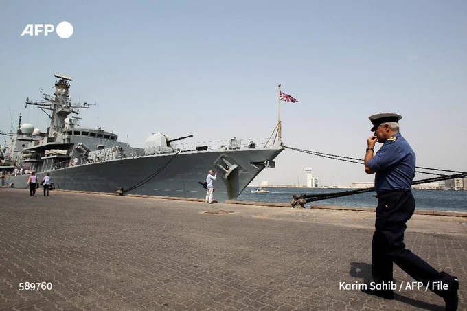 File photo shows a British officer walking past the HMS Sutherland British Royal Navy warship at the port of the Gulf emirate of Abu Dhabi on June 28, 2011