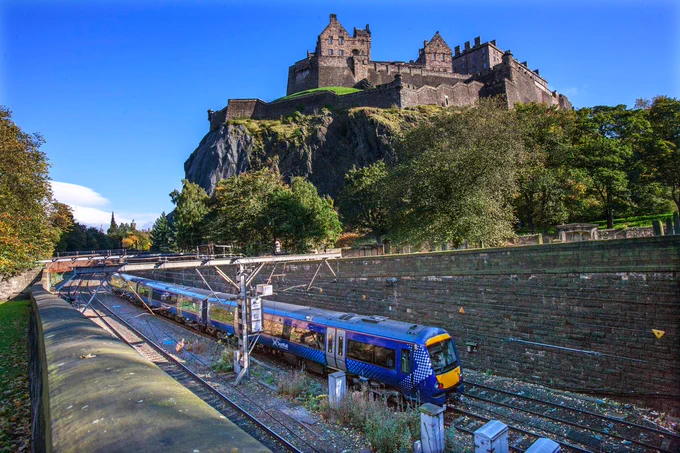 Scotrail train on the network next to Edinburgh Castle. 