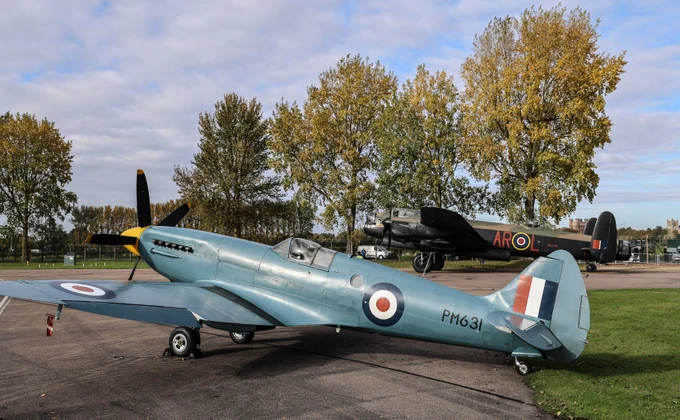 The Lancaster Bomber and Spitfire stationed outside near the Battle of Britain Memorial Flight hangar.