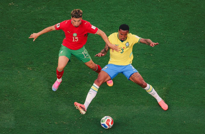 Morocco's midfielder Samir El Mourabet and Brazil's Gabriel Magalhaes fight for the ball during the 2026 World Cup Group C football match between Brazil and Morocco