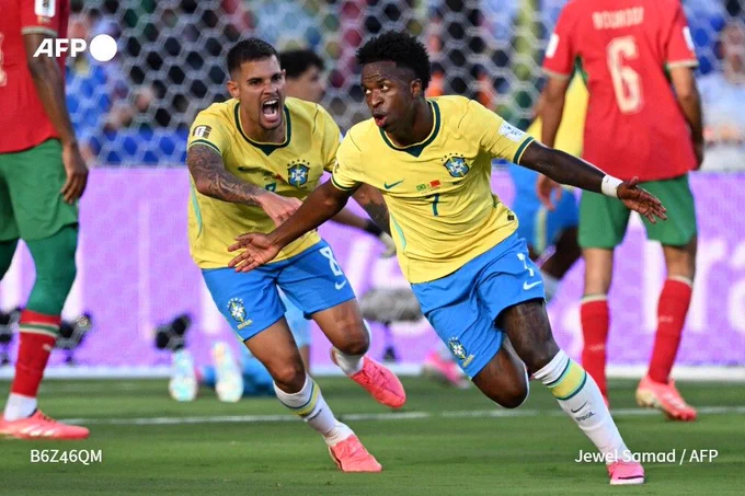 Brazil forward Vinicius Junior (R) celebrates scoring his team's first goal during their 2026 World Cup Group C match against Morocco at the New York/New Jersey Stadium in East Rutherford on June 13, 2026