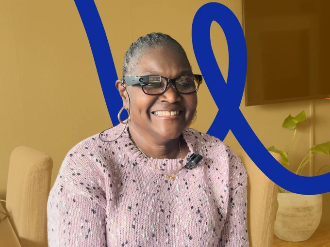 A woman wearing a pair of Envision Glasses which is running Ally, the most Accessible AI Assistant on them.