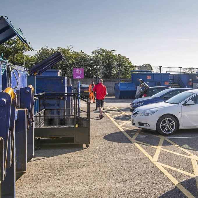 People unloading waste at a household waste recycling centre