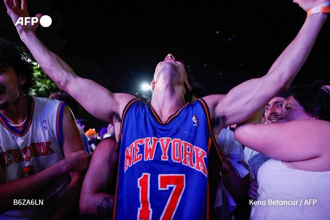 New York Knicks fans celebrate in Central Park in New York, on June 13, 2026 after their team beat the San Antonio Spurs in Game 5 of the NBA Finals to win the series