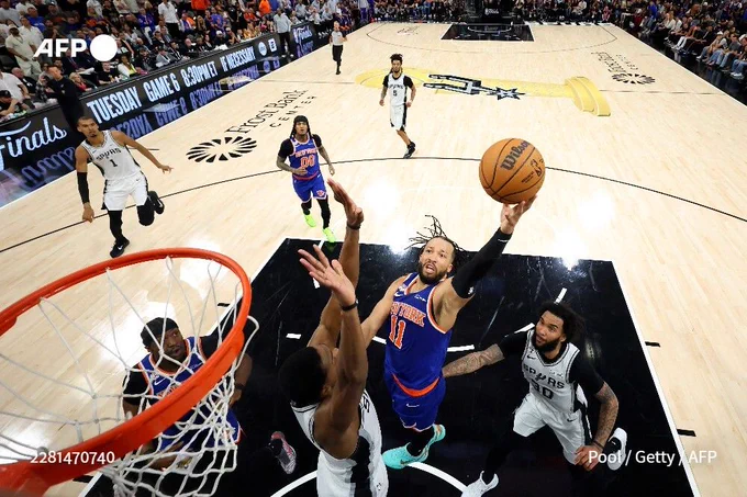 Jalen Brunson of the New York Knicks (C) shoots the ball against the San Antonio Spurs during the second half in Game Five of the 2026 NBA Finals at Frost Bank Center in San Antonio, Texas, on June 13, 2026