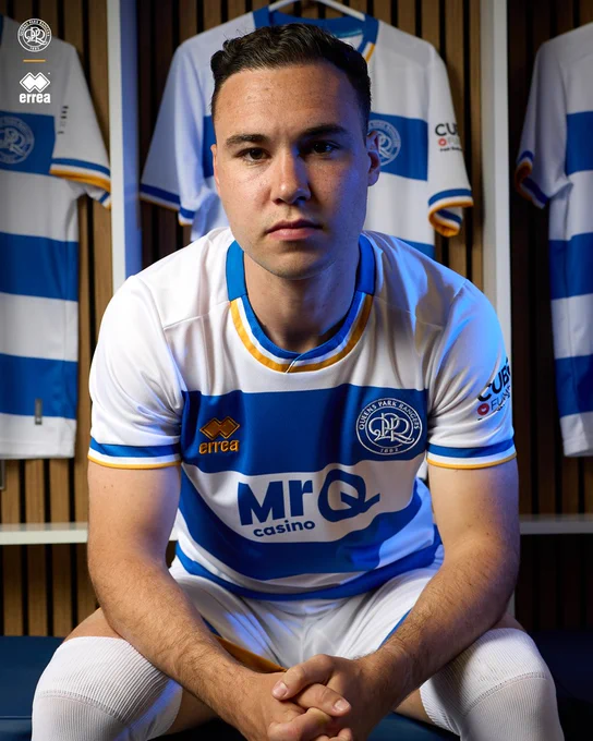 Harvey Vale modelling QPR's new 2026/27 home shirt.