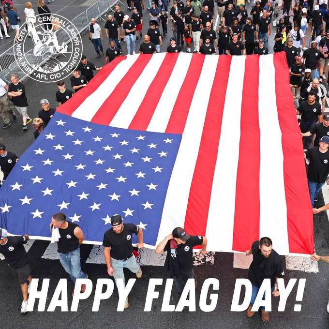 Members of Ironworkers Local 361 carrying a massive American flag in the NYC Labor Day Parade. 