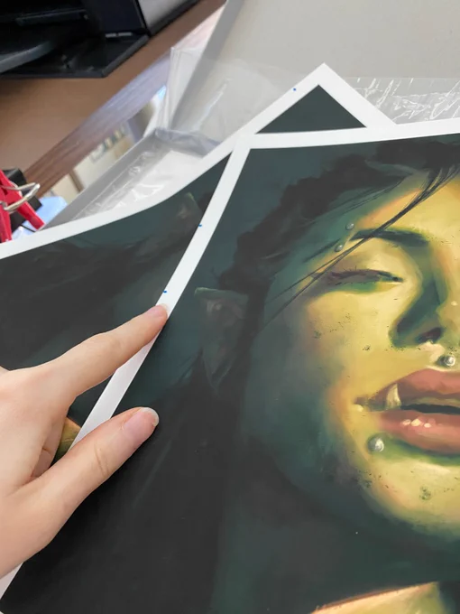 A picture of a test art print showing mistakes in the printing result. This is common with printing at home, this image showing the frustration of that with a hand pointing at the marks.