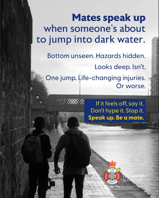 Two individuals walk alongside a canal in a cityscape. The weather appears overcast. Text on the image reads: "Mates speak up when someone’s about to jump into dark water. Bottom unseen. Hazards hidden. Looks deep. Isn’t. One jump. Life‑changing injuries. Or worse. If it feels off, say it. Don’t hype it. Stop it. Speak up. Be a mate." A logo for the Royal Life Saving Society UK is present at the bottom.