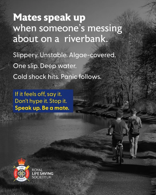 The image is a safety poster featuring two people walking with bicycles along a canal path. The text reads: "Mates speak up when someone’s messing about on a riverbank. Slippery. Unstable. Algae-covered. One slip. Deep water. Cold shock hits. Panic follows. If it feels off, say it. Don’t hype it. Stop it. Speak up. Be a mate." The Royal Life Saving Society UK logo is at the bottom.