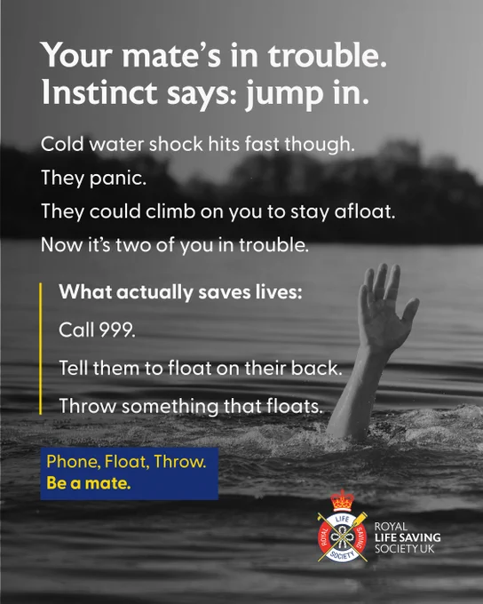 A person is partially submerged in water, with one hand raised above the surface, appearing to signal for help. The background shows a darkened silhouette of trees. Text encourages calling for emergency services and advises having the person float on their back and throwing something that floats to them. The Royal Life Saving Society UK logo is displayed.