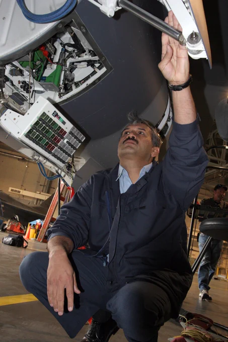 Group Captain Mujahid Anwar Khan inspecting the landing gear well. Notice the circuit breaker panel.