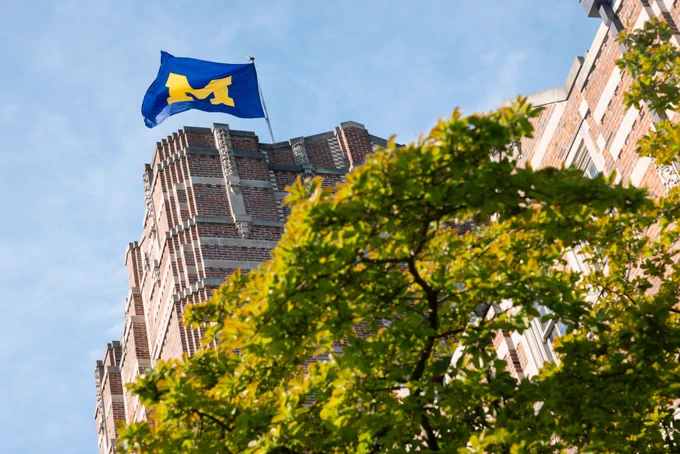 Looking up at the flag on top of the Michigan Union.