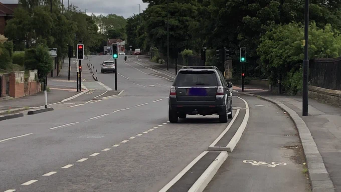 Picture of Elswick Road , Newcastle. Shows a kerb-protected cycle lane with adjacent parking bays.