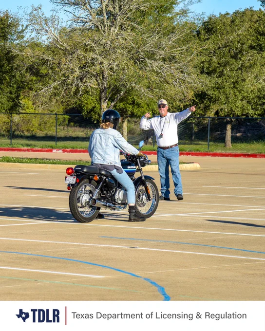 A person rides a motorcycle in a parking lot, receiving instructions from another standing nearby. The setting is an open area with trees in the background. The Texas Department of Licensing & Regulation logo is visible at the bottom of the image.