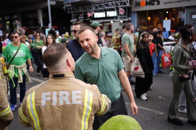 Zack shaking a firefighters hand