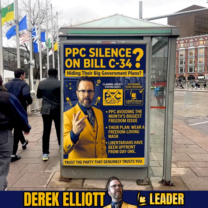 A professional photograph of a bus shelter advertisement in a city. The poster has a dark blue background with bold yellow text that reads, "PPC SILENCE ON BILL C-34? Hiding Their Big Government Plans?" Below the headline is a photo of Derek Elliott, Leader of the Libertarian Party of Canada, wearing a yellow suit jacket over a dark blue shirt and patterned tie. To the right, the poster compares the People's Party of Canada logo, labeled "CLAIMING LIBERTY, STAYING QUIET," with the Libertarian Party of Canada logo, labeled "DEFENDING YOUR FREEDOM." Bullet points on the poster state: "PPC AVOIDING THE MONTH'S BIGGEST FREEDOM ISSUE," "THEIR PLAN: WEAR A FREEDOM-LOVING MASK," and "LIBERTARIANS HAVE BEEN UPFRONT FROM DAY ONE." The bottom text reads, "TRUST THE PARTY THAT GENUINELY TRUSTS YOU." The very bottom border of the image features a dark blue banner with the text "DEREK ELLIOTT" and "LEADER" next to another portrait of Derek Elliott.