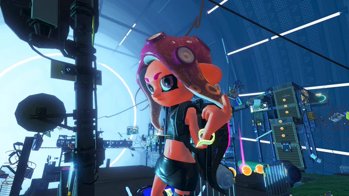 Screenshot from Splatoon 2: Octo Expansion. Female Agent 8, a tanned Octoling with purple hair, stands among a convoluted test chamber with floating 90s technology. She is wearing a leather crop top and skirt, a yellow wristband, and is glancing at the camera while playing with her hair.