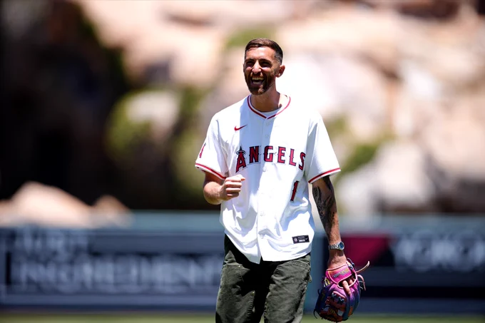 US Men’s National Team soccer goalie Matt Turner pumps his fist as he walks off the mound after tossing a strike for the game’s ceremonial first pitch. 