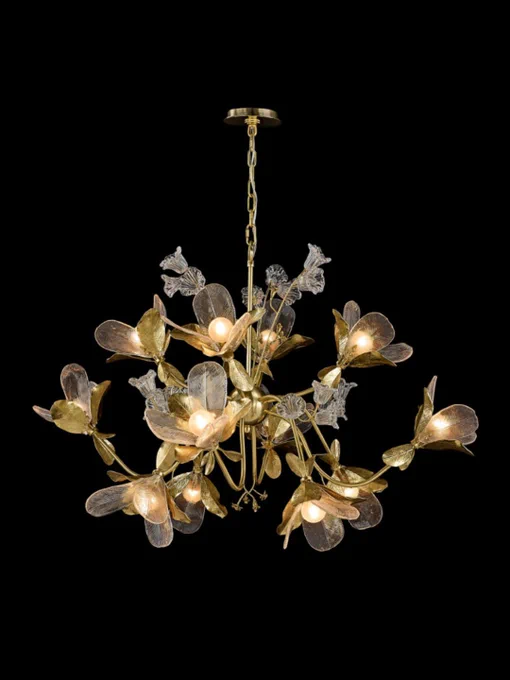 The Dryad Chandelier by John Richard featuring organically textured brass leaves, etched glass floral details, and warm glowing lights arranged in a sculptural botanical-inspired chandelier against a black background.
