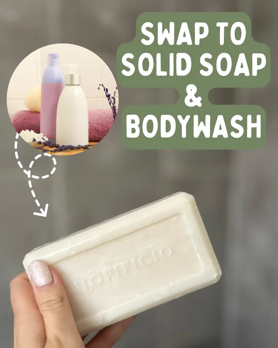 Photo of a white bar of soap being held up in front of a grey background. In top corner is a circle containing a photo of shampoo and conditioner bottles. A white dotted arrow points from the shampoo bottles to the shampoo bars. White text on a green background in top reads 'swap to solid soap and bodywash'.