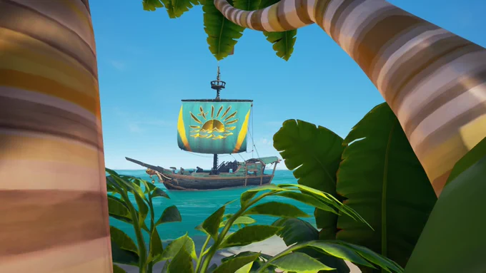 A screenshot of Sea of Thieves showing a ship next to an island, framed by trees and bushes. The ship sports a single sail of blue, with yellow lines running up either side and a golden emblem of a sun peeking over the horizon at its centre.