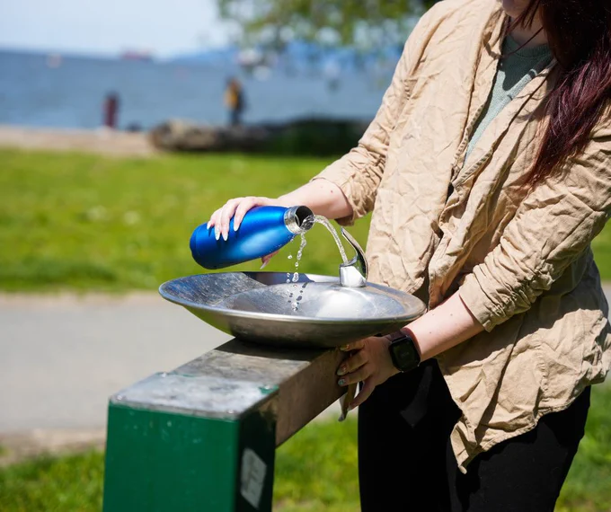 A person filling up a water bottle.