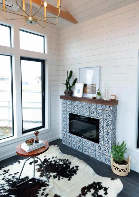Living room fireplace with patterned tile and walnut mantel
