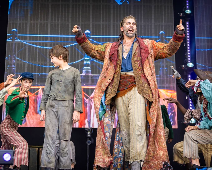 A photo of the cast of Oliver! performing on stage at West End LIVE.